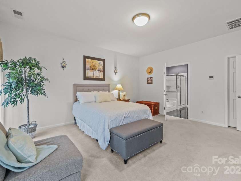 10217 Linksland Drive, Huntersville, NC 28078.  MLS# CAR4281355, YatesRealty ID 26573. Main floor primary bedroom has room for king-size bed, larger dresser, sitting area.
