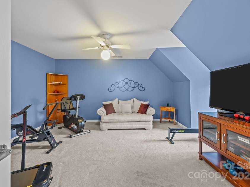 10217 Linksland Drive, Huntersville, NC 28078.  MLS# CAR4281355, YatesRealty ID 26573. One of the two large secondary bedrooms is currently used as an exercise room, showcasing its versatility and generous space for any lifestyle need.
