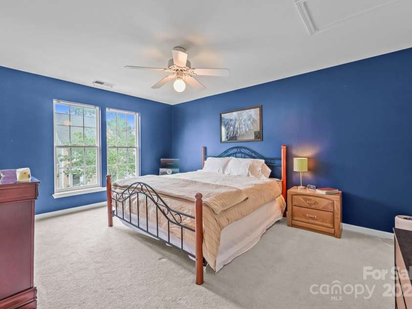 10217 Linksland Drive, Huntersville, NC 28078.  MLS# CAR4281355, YatesRealty ID 26573. One of two large secondary bedrooms offers plenty of space and comfort, making it perfect for family, guests, or a personalized retreat. Features: walk-in closet, room for king-size bed.