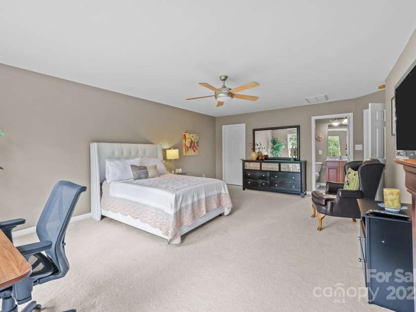10217 Linksland Drive, Huntersville, NC 28078.  MLS# CAR4281355, YatesRealty ID 26573. Second floor primary suite has room for king-size bed, larger dresser, sitting and work area. Features a walk-in closet and en-suite bathroom.