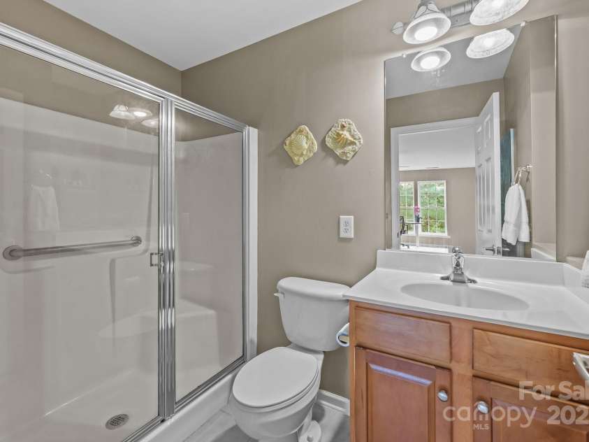 10217 Linksland Drive, Huntersville, NC 28078.  MLS# CAR4281355, YatesRealty ID 26573. Second primary suite includes a private, en-suite bathroom, providing ultimate convenience and privacy for guests or family members.
