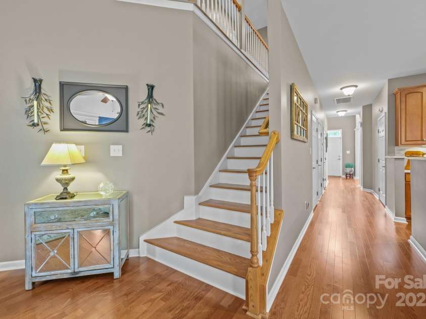 10217 Linksland Drive, Huntersville, NC 28078.  MLS# CAR4281355, YatesRealty ID 26573. Staircase with elegant wood treads leads gracefully to the second floor, adding warmth and timeless charm to the home.