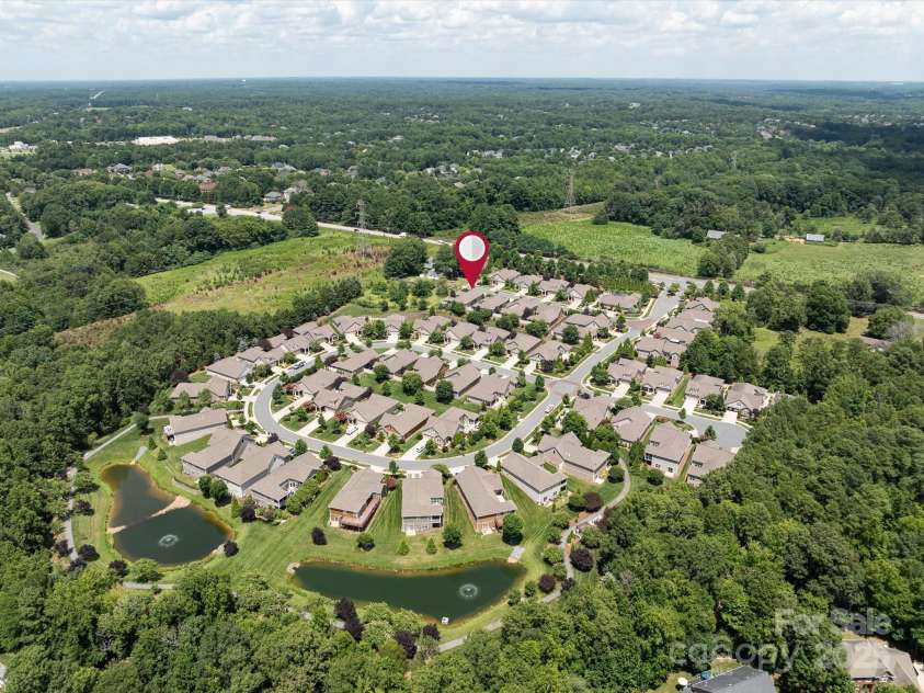 1313 Haywood Park Drive, Waxhaw, NC 28173.  MLS# CAR4279018, YatesRealty ID 26575. Community from drone view featuring community pond, swimming pool and clubhouse