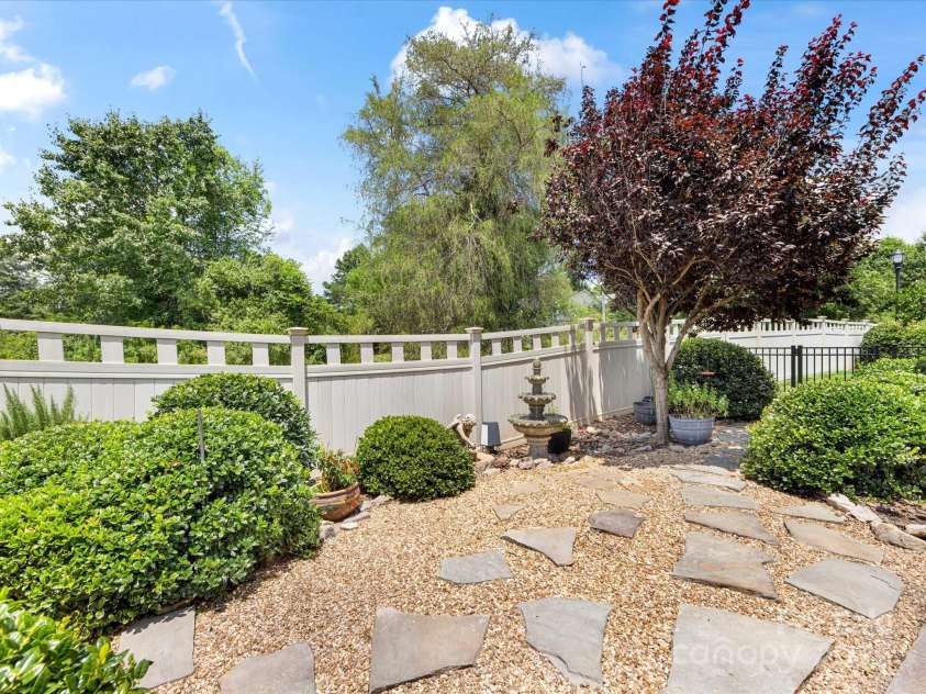 1313 Haywood Park Drive, Waxhaw, NC 28173.  MLS# CAR4279018, YatesRealty ID 26575. Custom Landscaping with Stepping Stones, Rock Borders & Extra Plantings Outside Fence for Added Privacy