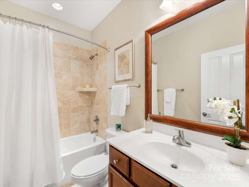 1313 Haywood Park Drive, Waxhaw, NC 28173.  MLS# CAR4279018, YatesRealty ID 26575. Guest Bathroom Featuring Tile Shower, Stylish Flooring & Recessed Lighting