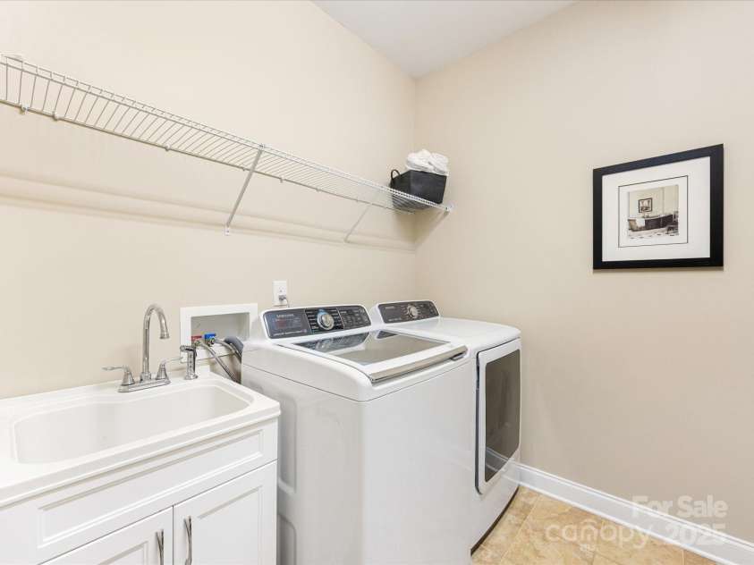 1313 Haywood Park Drive, Waxhaw, NC 28173.  MLS# CAR4279018, YatesRealty ID 26575. True Laundry Room with Utility Sink, Ample Storage, New Hot Water Heater & Tile Flooring