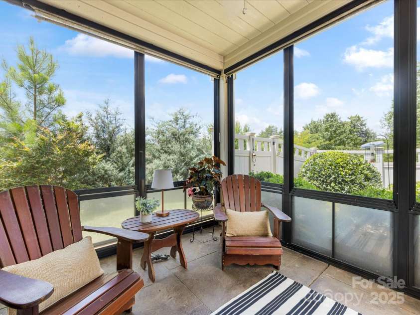 1313 Haywood Park Drive, Waxhaw, NC 28173.  MLS# CAR4279018, YatesRealty ID 26575. Upgraded Screened Porch off Primary Bedroom with Slide-Down Screens & Clear Panels for Year-Round Enjoyment - Owners have a TV on the porch as well.