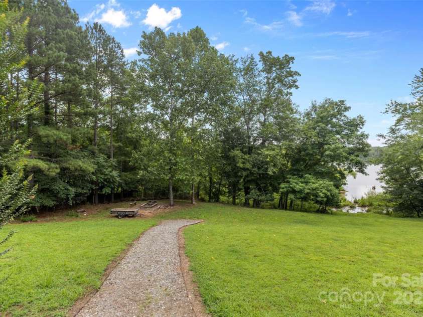 185 Greens Road, Granite Falls, NC 28630.  MLS# CAR4275528, YatesRealty ID 26594. Walkway to the fire pit and lake