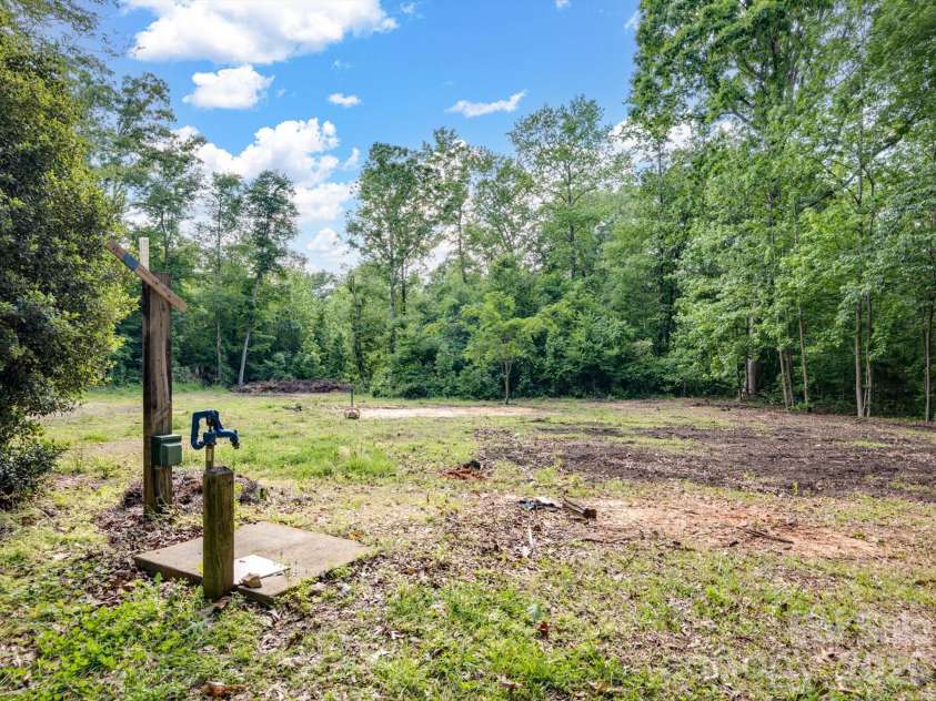 6717 Mccain Boulevard, Waxhaw, NC 28173.  MLS# CAR4372669, YatesRealty ID 26599. Water pump in front yard