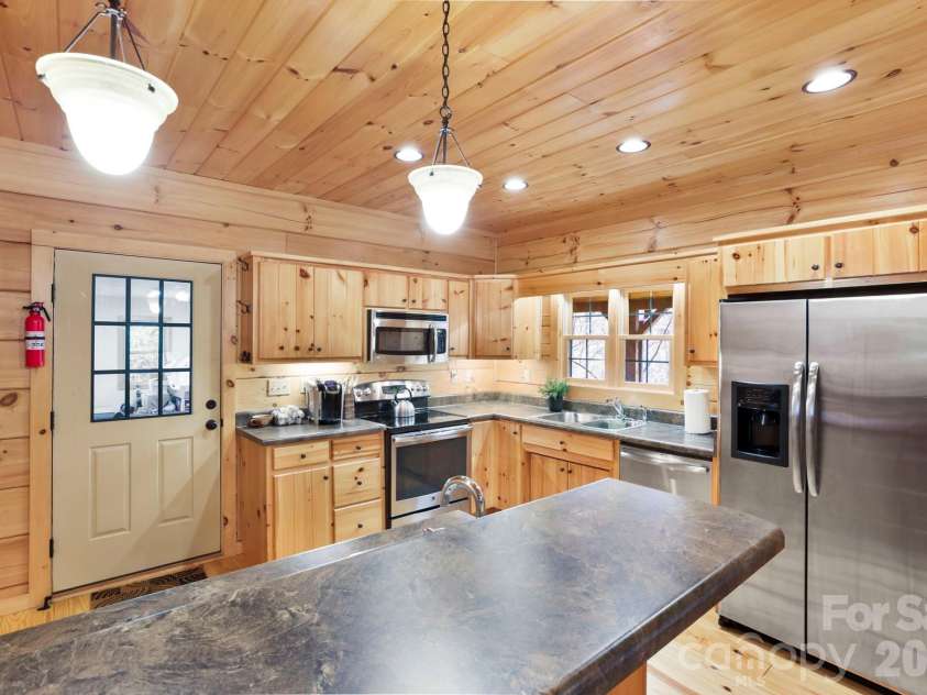 213 Big Valley Road, Pisgah Forest, NC 28768.  MLS# CAR4353319, YatesRealty ID 26629. Kitchen with a bar 