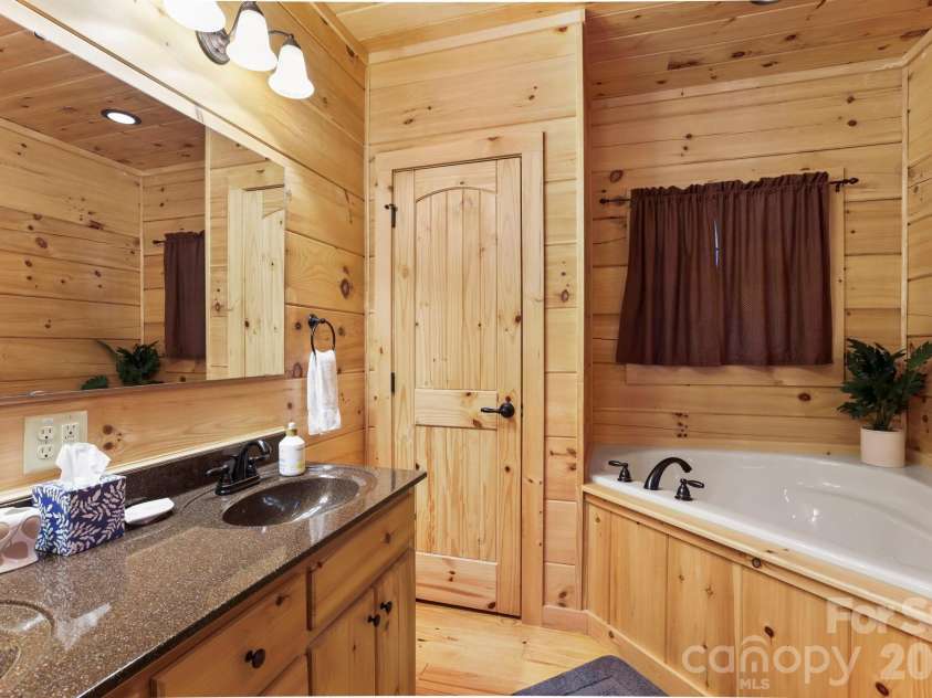 213 Big Valley Road, Pisgah Forest, NC 28768.  MLS# CAR4353319, YatesRealty ID 26629. Primary bath with 2 sinks, Garden tub and shower 
