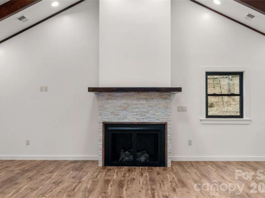 453 Friendly Acres Drive, Waynesville, NC 28786.  MLS# CAR4351574, YatesRealty ID 2664. Warm up by fire while enjoying the views
