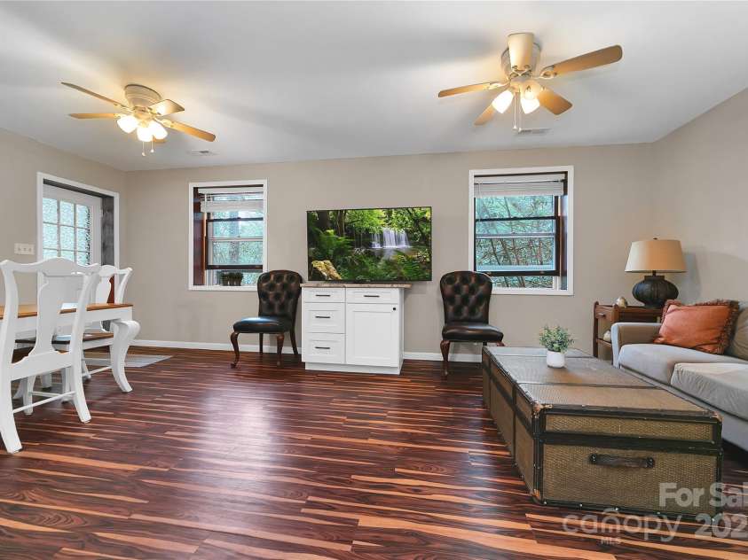 3703 Connestee Trail, Brevard, NC 28712.  MLS# CAR4215102, YatesRealty ID 26660. Downstairs Family Room