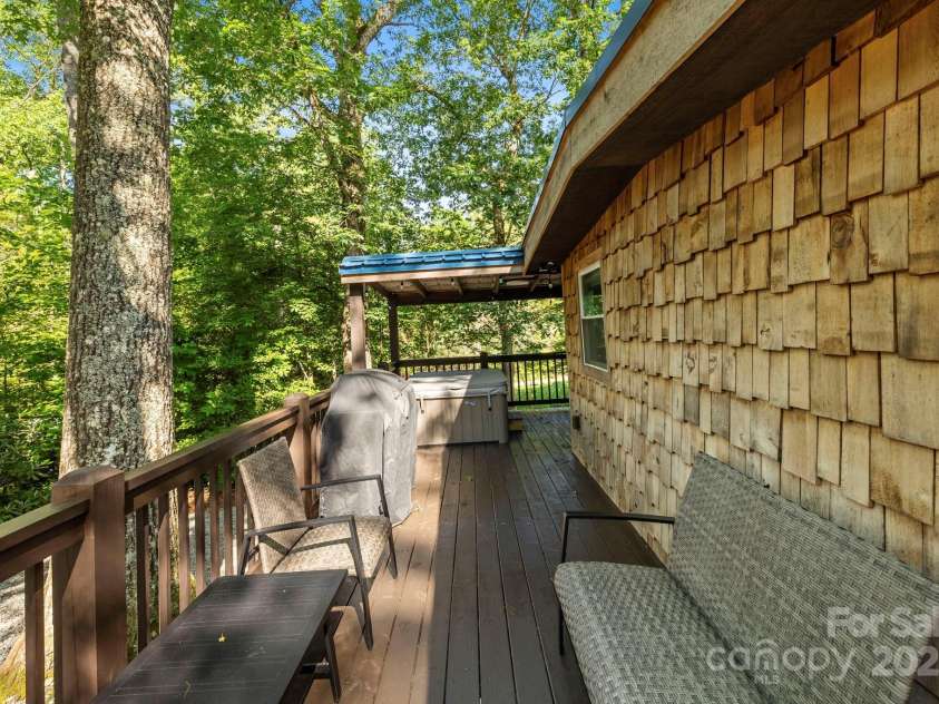 40 Squirrel Lane, Sapphire, NC 28774.  MLS# CAR4272442, YatesRealty ID 26666. Wraparound Porch