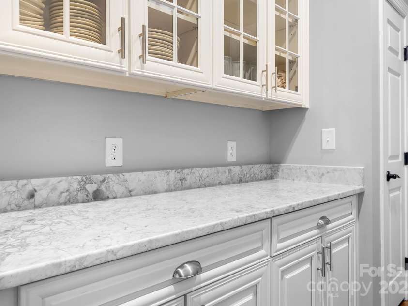 7191 Grist Mill Court, Denver, NC 28037.  MLS# CAR4221551, YatesRealty ID 26668. Butlers pantry with quartzite counter tops, china storage closet