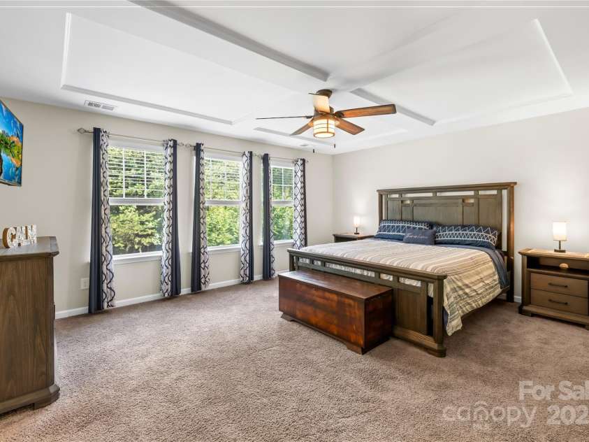 183 Rustling Waters Drive, Mooresville, NC 28117.  MLS# CAR4303069, YatesRealty ID 2667. Elegant primary with coffered ceiling