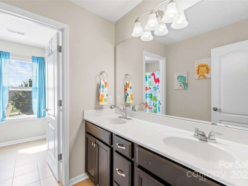 183 Rustling Waters Drive, Mooresville, NC 28117.  MLS# CAR4303069, YatesRealty ID 2667. Upper level hall bath with two basin vanity