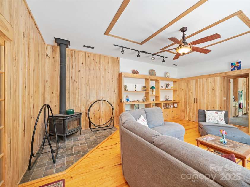 2490 US 80 Highway, Burnsville, NC 28714.  MLS# CAR4282852, YatesRealty ID 26673. Living Room with Woodstove