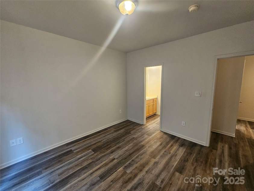 606 North Street, Belmont, NC 28012.  MLS# CAR4265350, YatesRealty ID 26675. Unit A- Bedroom with laminate flooring