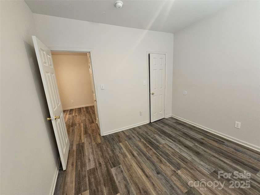 606 North Street, Belmont, NC 28012.  MLS# CAR4265350, YatesRealty ID 26675. Unit A- Bedroom with laminate flooring