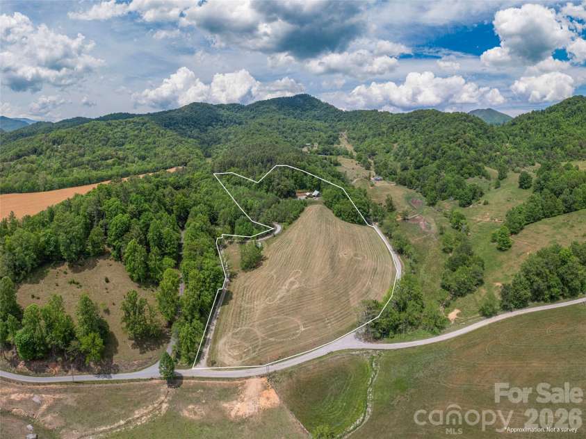 461 Ferguson Cove Loop, Clyde, NC 28721.  MLS# CAR4354575, YatesRealty ID 26678. Lower barn and second firepit area plus hayfield and potential for your desires