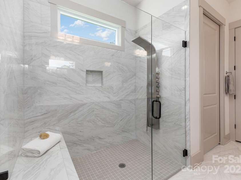 19031 Brandon James Drive, Cornelius, NC 28031.  MLS# CAR4256290, YatesRealty ID 26681. Large zero entry shower with bench