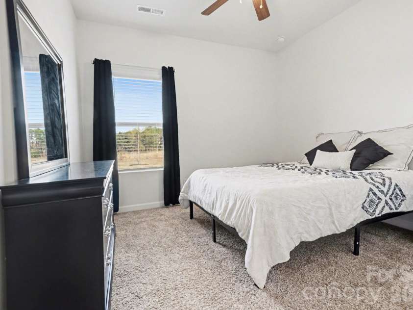 11416 Solstice Way, Huntersville, NC 28078.  MLS# CAR4361145, YatesRealty ID 26688. 5th Bedroom on the Main Floor with recessed lights, carpet, nearby full bathroom, and ceiling fan