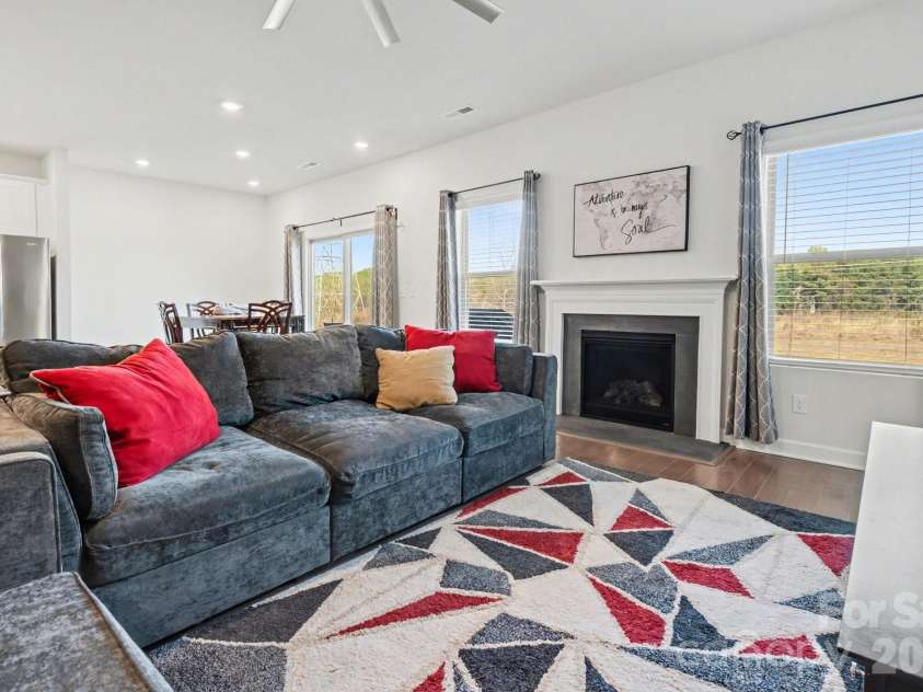 11416 Solstice Way, Huntersville, NC 28078.  MLS# CAR4361145, YatesRealty ID 26688. Living Room with a ceiling fan, large windows for natural light, a gas log fireplace and more..