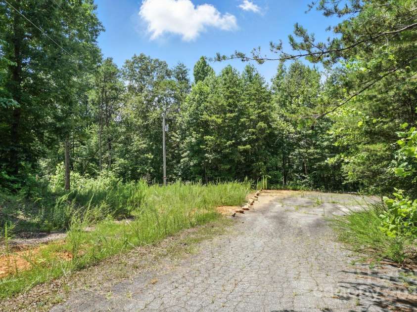 280 Mills Creek Road, Iron Station, NC 28080.  MLS# CAR4277070, YatesRealty ID 26706. Road on the side of home, showing easement