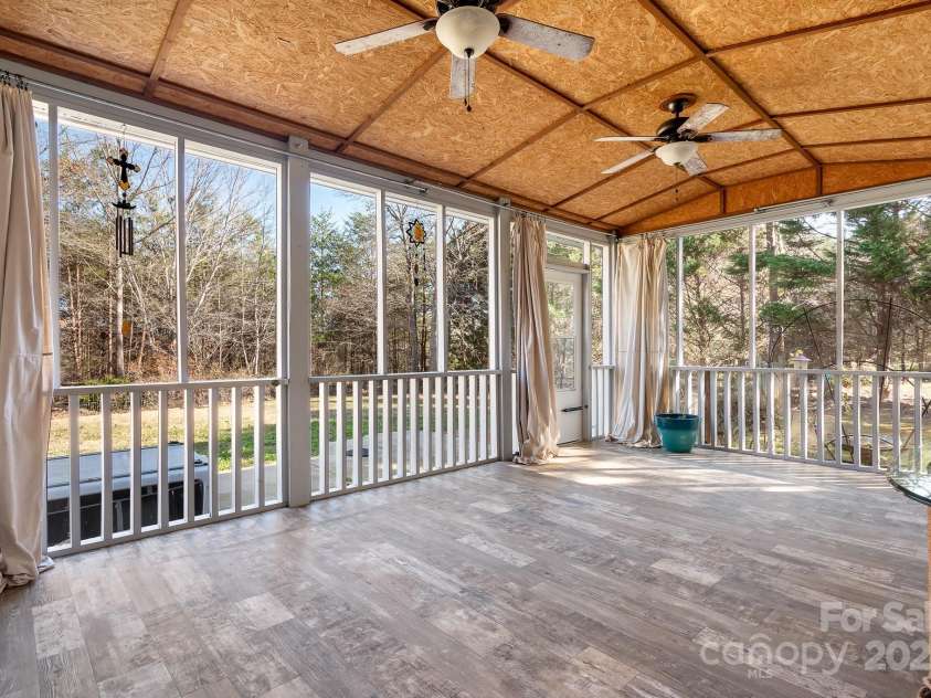 449 Doves Crest Court, Stanley, NC 28164.  MLS# CAR4220525, YatesRealty ID 2672. The screen porch is large enough to accomodate the best of gatherings and a hot tub!