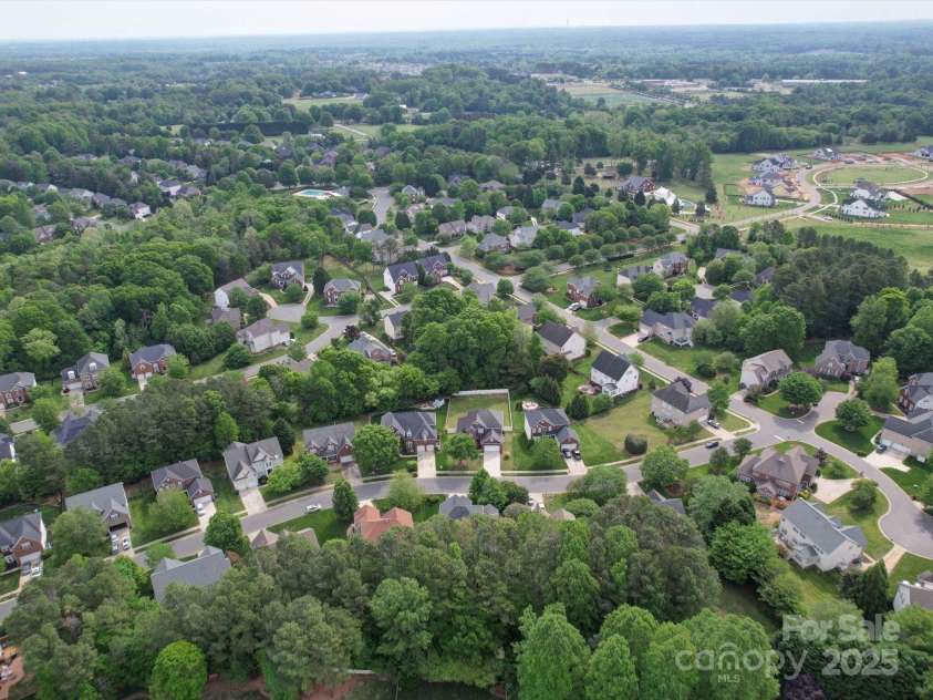 7642 Horseshoe Creek Drive, Huntersville, NC 28078.  MLS# CAR4249944, YatesRealty ID 26720. Aerial view of home showing proximity to community pool/amenities and nearby school, nature reserve and lake