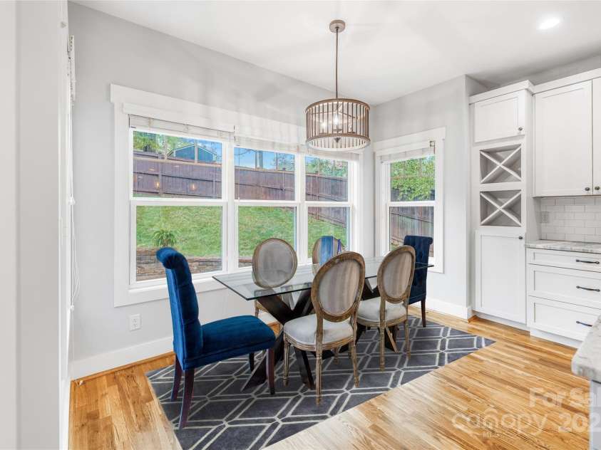 45 Tahkieostie Trail, Asheville, NC 28806.  MLS# CAR4250758, YatesRealty ID 26721. Off kitchen dining area looking onto large backyard. Virtual staging.