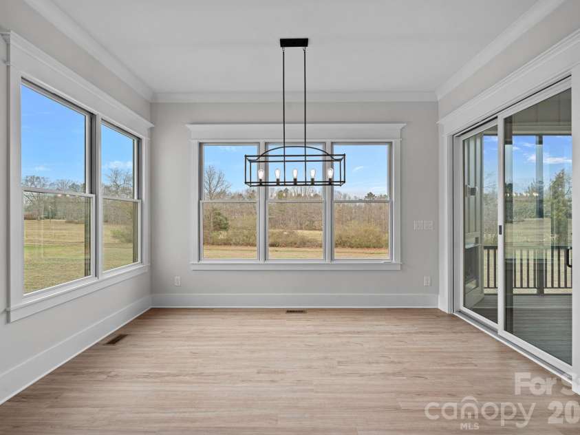 111 Monbo Meadows Lane, Statesville, NC 28677.  MLS# CAR4336887, YatesRealty ID 26730. Dining area with sliders to the screened porch.