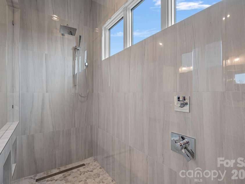 111 Monbo Meadows Lane, Statesville, NC 28677.  MLS# CAR4336887, YatesRealty ID 26730. Stunning walk in shower with natural light.