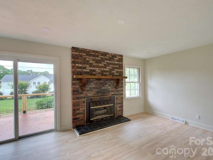 1195 Holly Springs Road, Lyman, SC 29365.  MLS# CAR4387941, YatesRealty ID 26730. Den off kitchen with fireplace