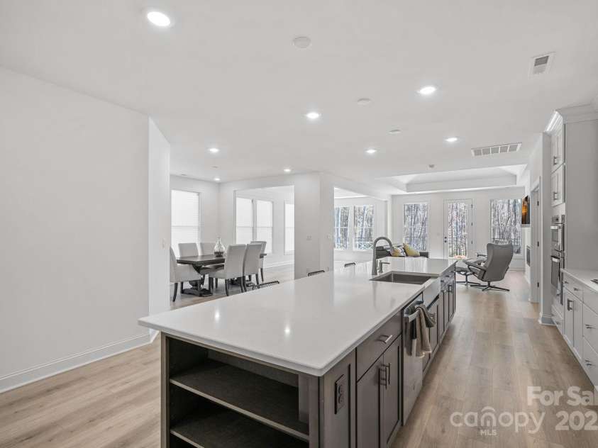 218 Alenda Lux Circle, Mooresville, NC 28115.  MLS# CAR4311950, YatesRealty ID 26739. LOOKING OVER  THE KITCHEN ISLAND INTO THE DINING ROOM, LOUNGE AND LIVING ROOM.