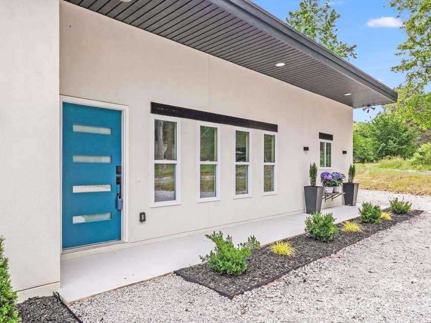 6907 Lancaster Highway, Waxhaw, NC 28173.  MLS# CAR4247480, YatesRealty ID 26742. A cheerful turquoise blue front door welcomes you, featuring a sleek black modern door handle and a convenient keyless entry pad for added security and ease.