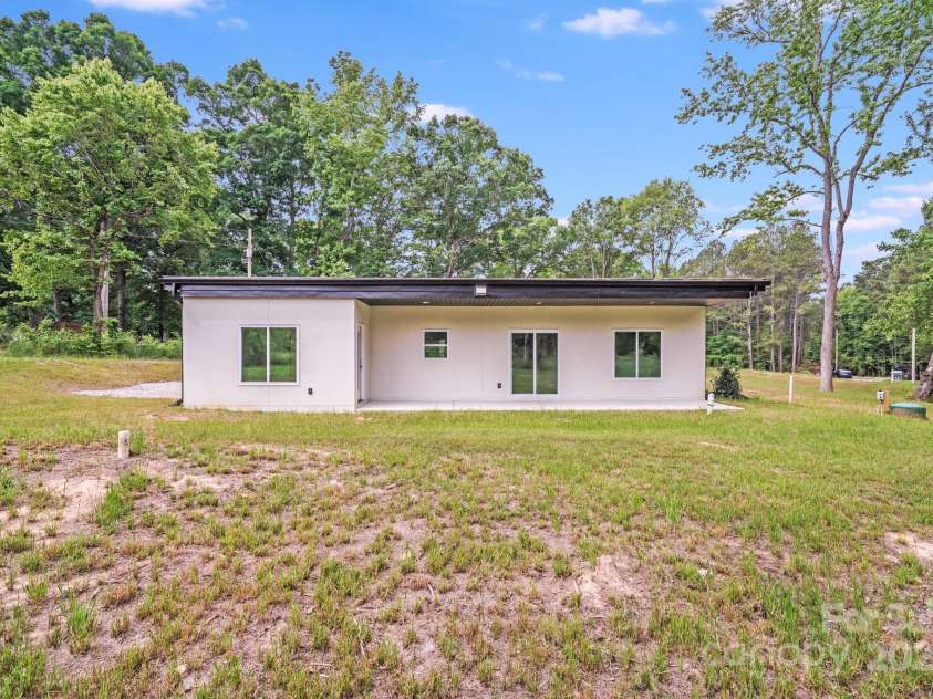 6907 Lancaster Highway, Waxhaw, NC 28173.  MLS# CAR4247480, YatesRealty ID 26742. Just off the covered back patio, a level backyard offers plenty of open space for play, entertaining, gardening, or future outdoor enhancements. Surrounded by mature trees for privacy and shade, this backyard is perfec