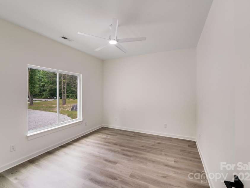 6907 Lancaster Highway, Waxhaw, NC 28173.  MLS# CAR4247480, YatesRealty ID 26742. Perfect for a home office, gym, hobby space, or guest retreat, this versatile flex room features a large double window framing picturesque views of the front yard, circular driveway, and landscaped island.