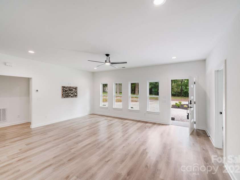 6907 Lancaster Highway, Waxhaw, NC 28173.  MLS# CAR4247480, YatesRealty ID 26742. The great room, with its full wall of windows, overlooks the front yard, offering a clear view of the large circular driveway and beautifully landscaped center island.