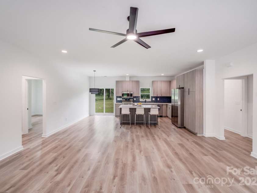 6907 Lancaster Highway, Waxhaw, NC 28173.  MLS# CAR4247480, YatesRealty ID 26742. The open-concept living, dining, and kitchen areas flow seamlessly together, featuring attractive natural wood-look luxury vinyl plank floors that add warmth and durability.