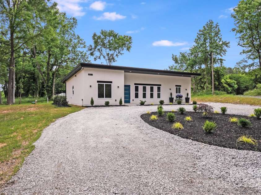 6907 Lancaster Highway, Waxhaw, NC 28173.  MLS# CAR4247480, YatesRealty ID 26742. This home is nestled on over an acre of level land, enhanced by large, mature trees that offer privacy, shade, and a serene natural backdrop.