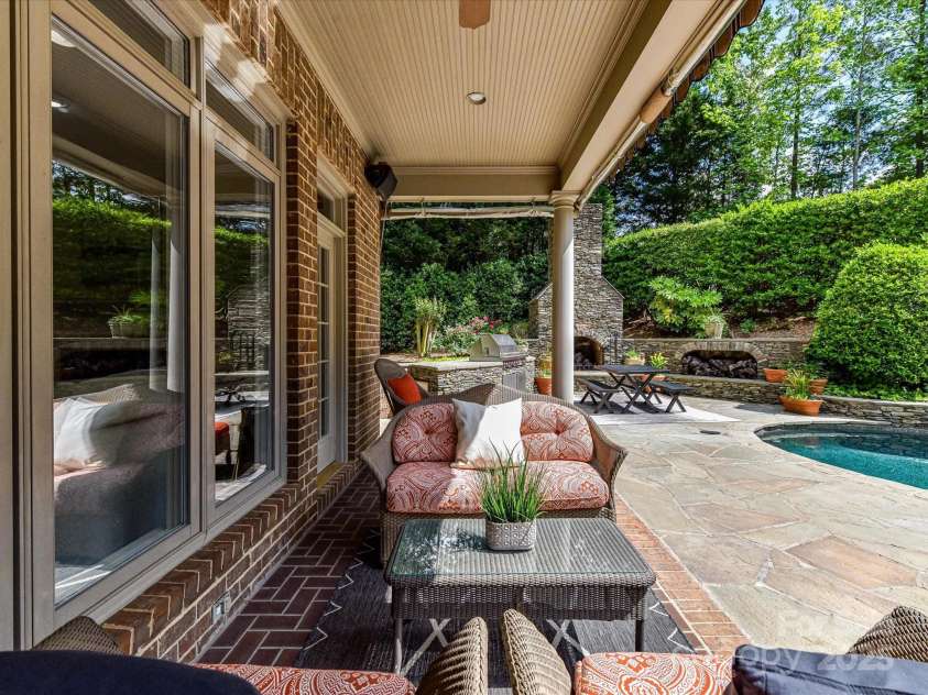 14650 Trading Path Way, Charlotte, NC 28277.  MLS# CAR4249159, YatesRealty ID 26743. Covered porch with herringbone patterned brick flooring AND all season roll-down sides and add'l awning extension