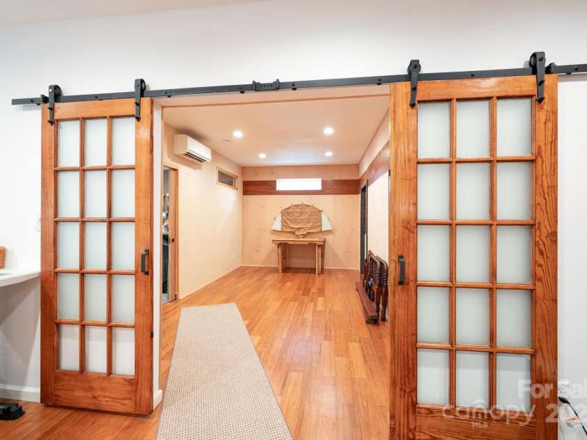 12 Asher Lane, Arden, NC 28704.  MLS# CAR4272445, YatesRealty ID 26758. Sliding Barn Doors In Basement Flex Space