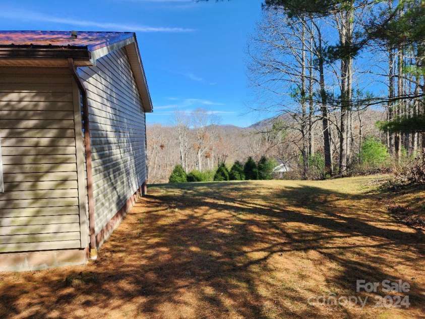 20 Coventry Lane, Burnsville, NC 28714.  MLS# CAR4199768, YatesRealty ID 268. Looking north along the east side of the house