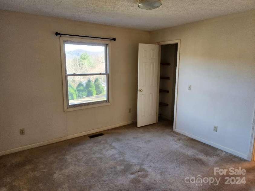 20 Coventry Lane, Burnsville, NC 28714.  MLS# CAR4199768, YatesRealty ID 268. Primary Bedroom showing door to walk-in closet