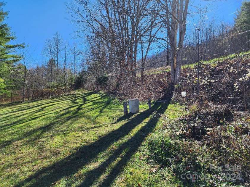 20 Coventry Lane, Burnsville, NC 28714.  MLS# CAR4199768, YatesRealty ID 268. Well located on edge the yard behind the house