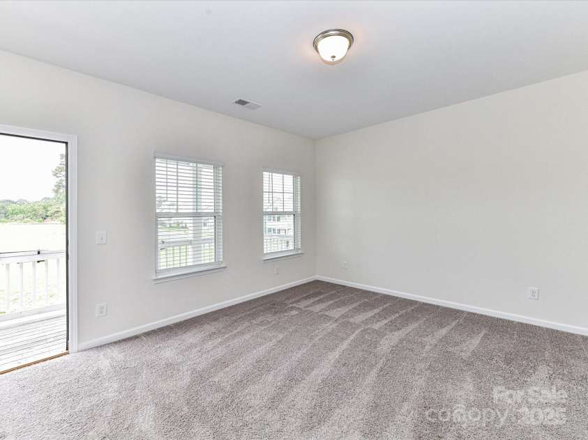 134 Kerri Dawn Lane, Locust, NC 28097.  MLS# CAR4294973, YatesRealty ID 26801. Bedroom #2 provides direct access to the balcony and plush carpeting