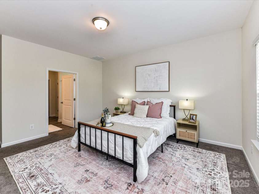 134 Kerri Dawn Lane, Locust, NC 28097.  MLS# CAR4294973, YatesRealty ID 26801. This spacious primary on the main offers a serene retreat with plush carpeting, ensuite bath and walk in closet!