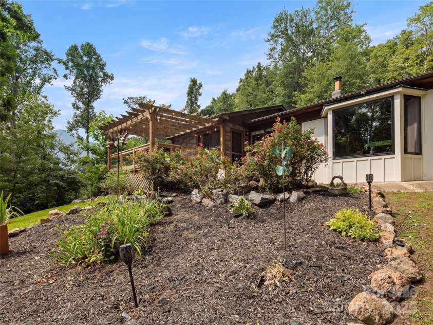 44 Sutton Knob Road, Candler, NC 28715.  MLS# CAR4252708, YatesRealty ID 26806. Front of home landscaping